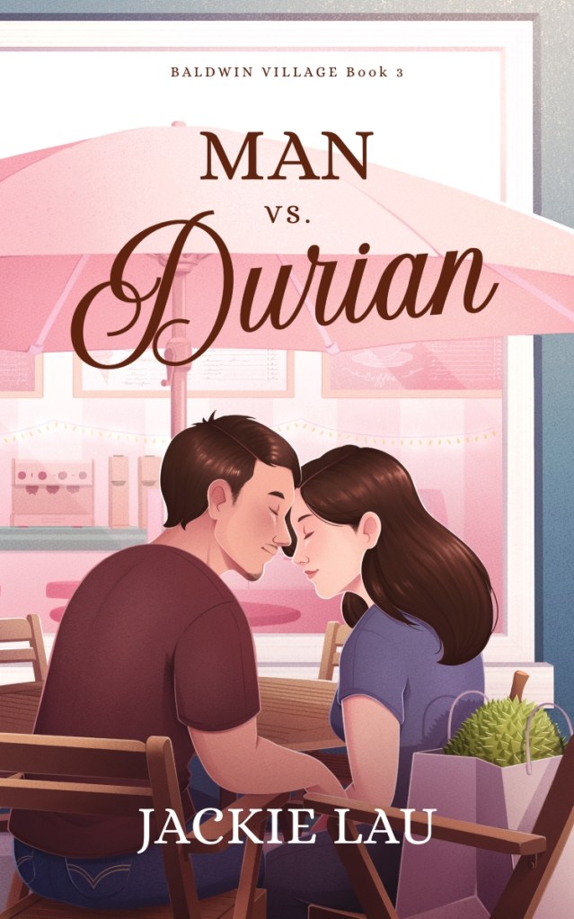 Illustrated cover of Asian man and woman, both wearing T-shirts, on a patio under an orangey-pink umbrella. They are sitting close together on wooden patio furniture, their foreheads touching, eyes closed. There is a durian in a shopping bag on the woman’s chair. Title above couple: Man vs. Durian. Author name at bottom: Jackie Lau